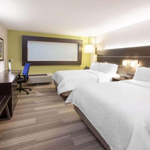 Hotel guest room with beds in front of blackout roller shade Toronto